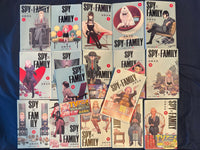 All 17 covers of the SPY x FAMILY Japanese manga set laid out together, two volumes still wearing their original anime obi bands